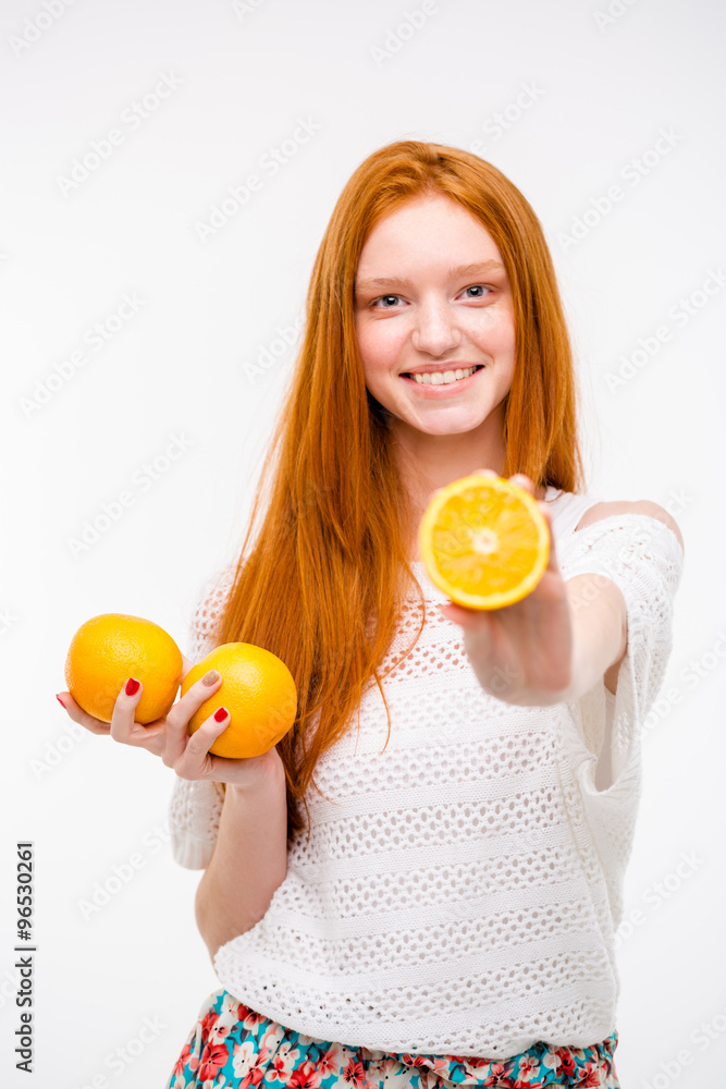 Portrait of pretty young woman holding juicy delicious orange Portrait of pretty young woman holding juicy delicious orange