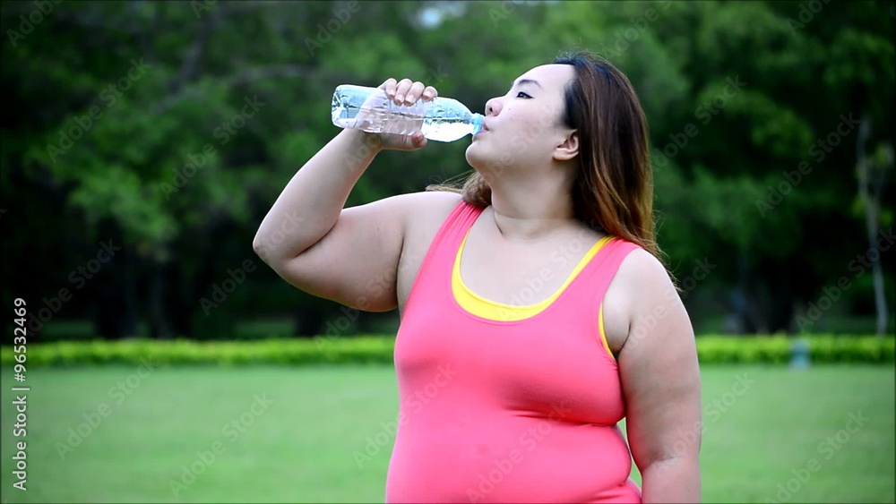 tired sport fat woman drink water in garden tired sport fat woman drink water in garden