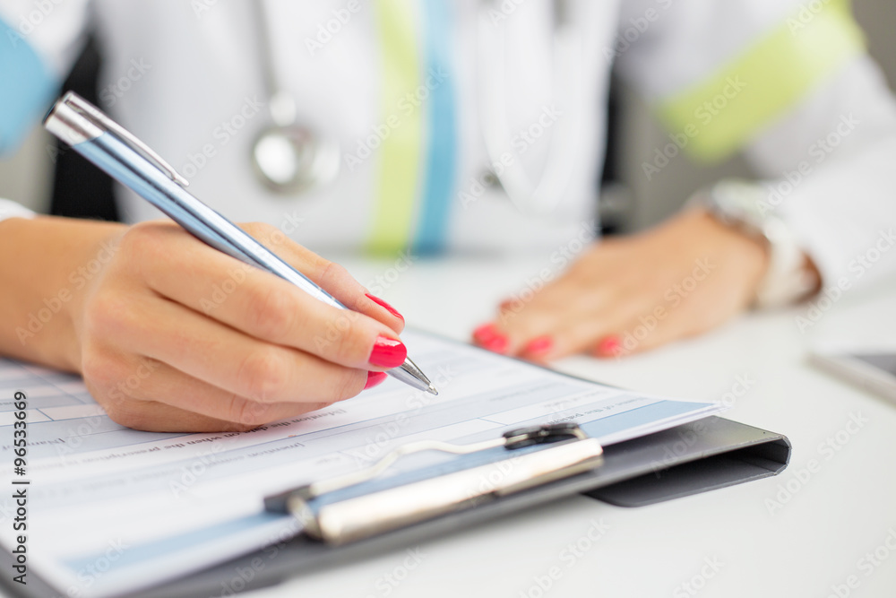 Doctor signing documents Doctor signing documents
