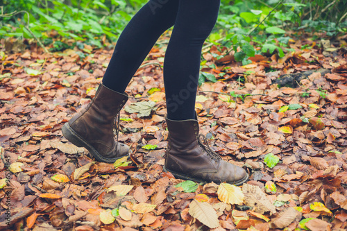 Feet of woman walking in leaves