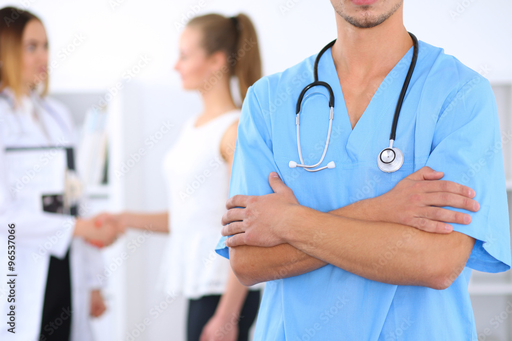 Unknown male surgeon doctor with stethoscope, crossed arms Unknown male surgeon doctor with stethoscope, crossed arms