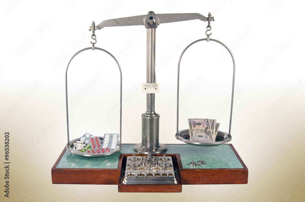 Old style pharmacy scale with drugs heavier than money Old style pharmacy scale with drugs heavier than money