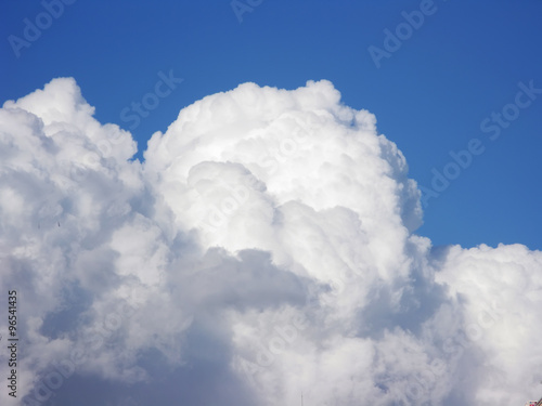 Blue sky with fluffy white clouds in day light