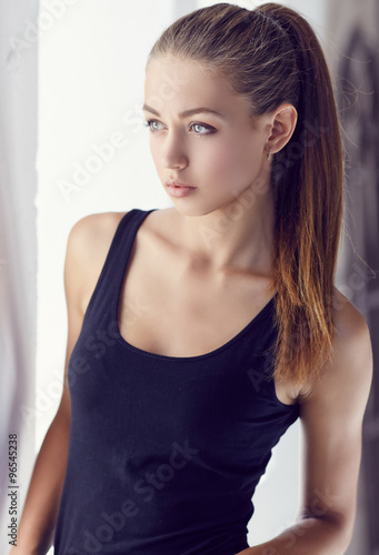 Portrait of young sensual girl in dark t shirt.