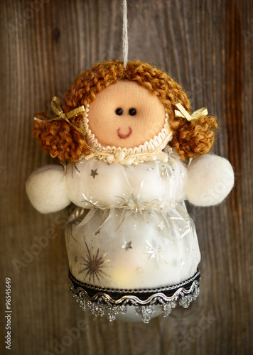 Christmas doll ornament on wood background