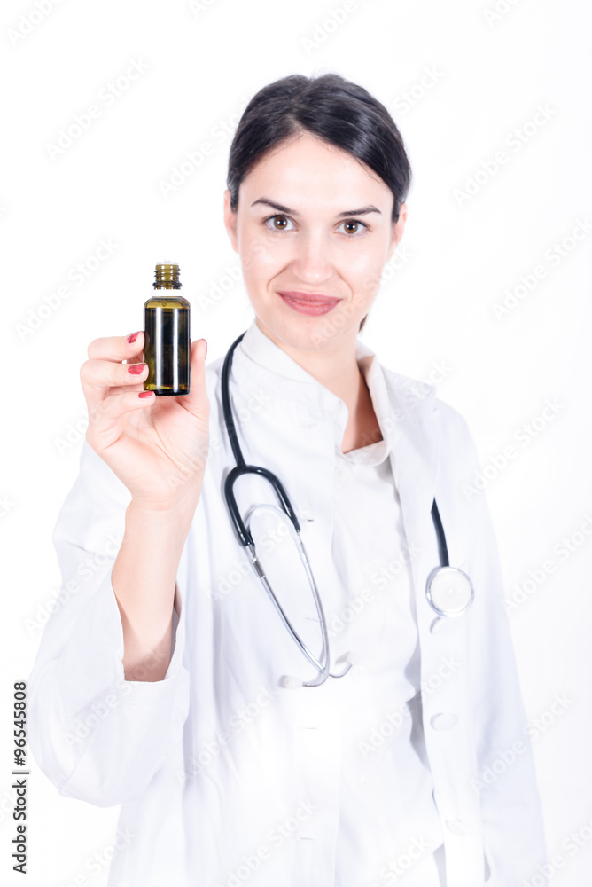 woman doctor holding small medicine bottle isolated on white woman doctor holding small medicine bottle isolated on white