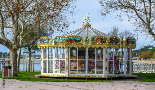 French colorful carousel in the park with wooden horses