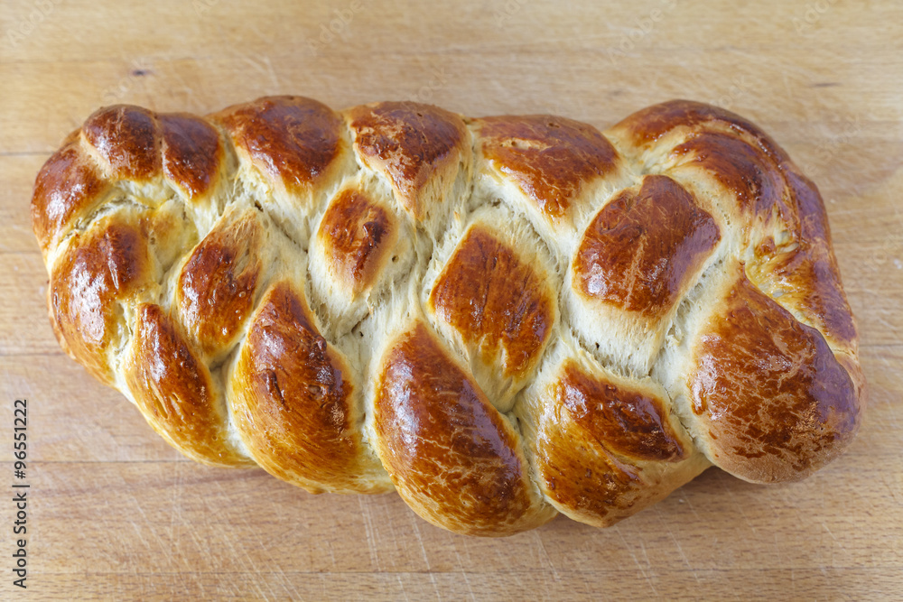 Loaf of sweet braided bread on Table Loaf of sweet braided bread on Table