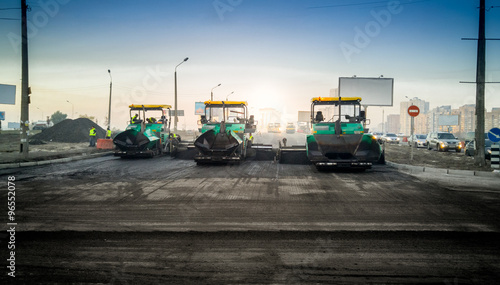 industrial machines laying asphalt on new road