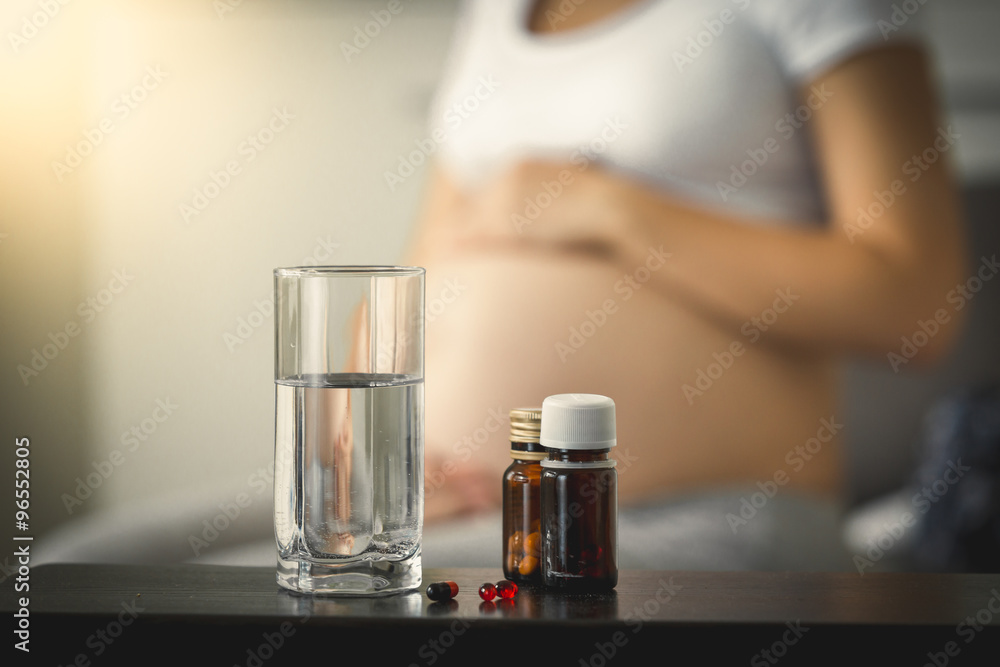 Conceptual photo of pregnancy healthcare. Medicines on table nex Conceptual photo of pregnancy healthcare. Medicines on table nex