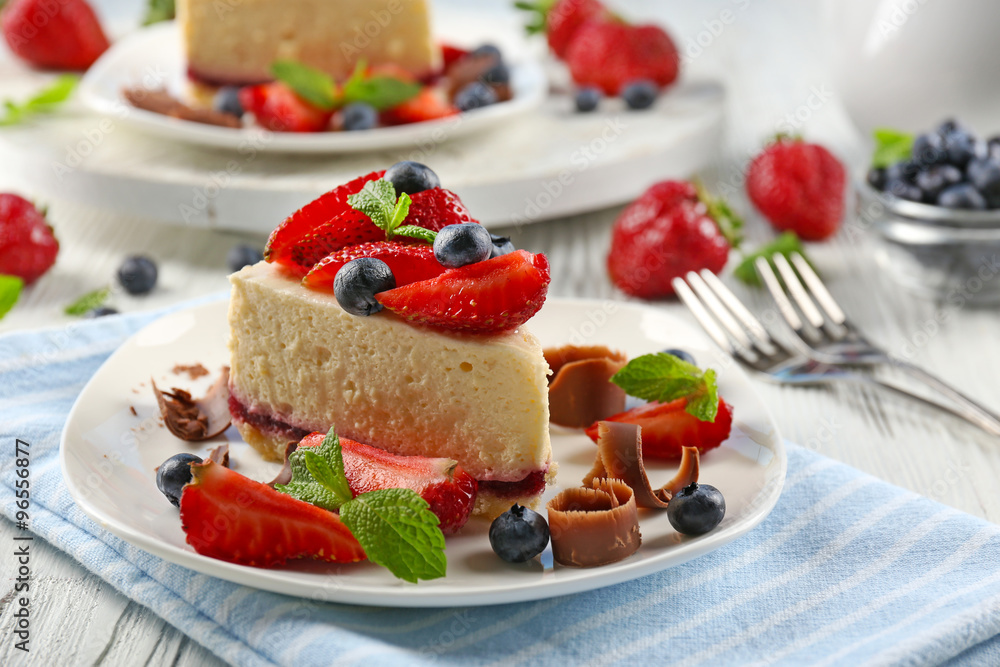 Delicious cheesecake with berries on table close up Delicious cheesecake with berries on table close up