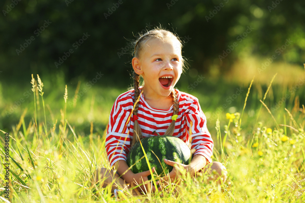 Small girl with watermelon on lawn Small girl with watermelon on lawn
