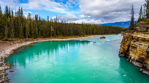 The  turquoise colored water of the Athabasca River immediately after the Falls and the Canyon in Jasper National Park in the Canadian Rockies