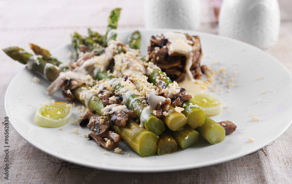 Appetizing dish with asparagus and mushrooms on served table in the restaurant Appetizing dish with asparagus and mushrooms on served table in the restaurant