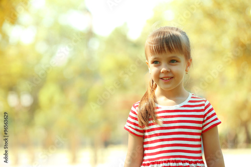 Little happy girl playing in park near the playground © Africa Studio