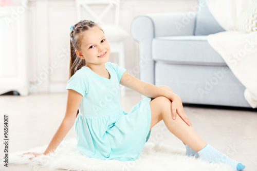 Little cute girl sitting on...