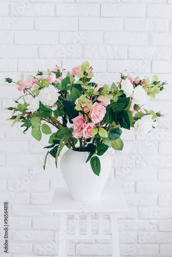 pink rose standing on a white table in minimalistic style 