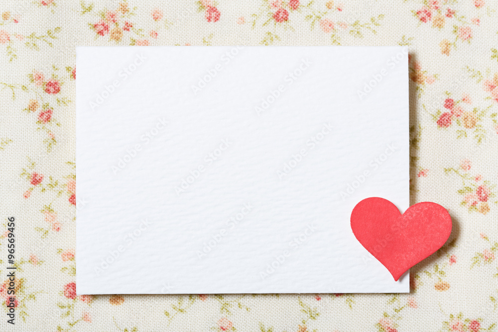White blank paper card with floral fabric
