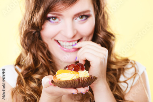 Closeup flirty woman eating fruit cake