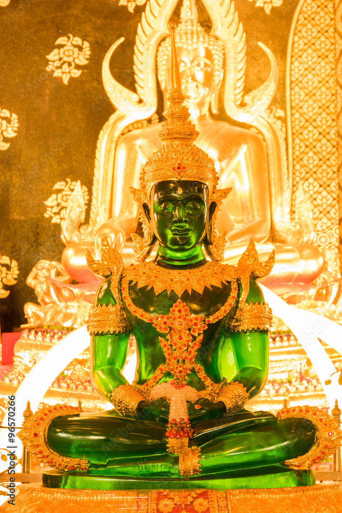 Fototapeta premium green buddha among other buddhas