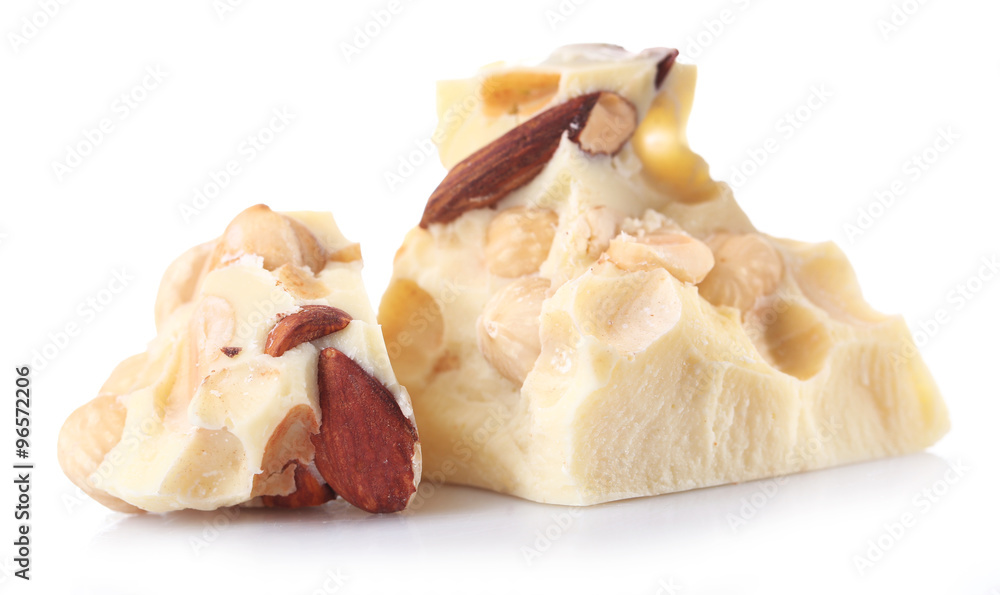 White chocolate pieces with nuts isolated on white White chocolate pieces with nuts isolated on white