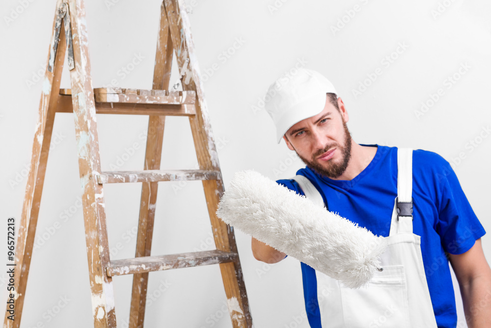 painter in white dungarees, blue t-shirt painter in white dungarees, blue t-shirt
