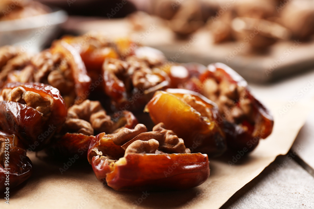 Walnut and date fruit on wooden table, close-up Walnut and date fruit on wooden table, close-up
