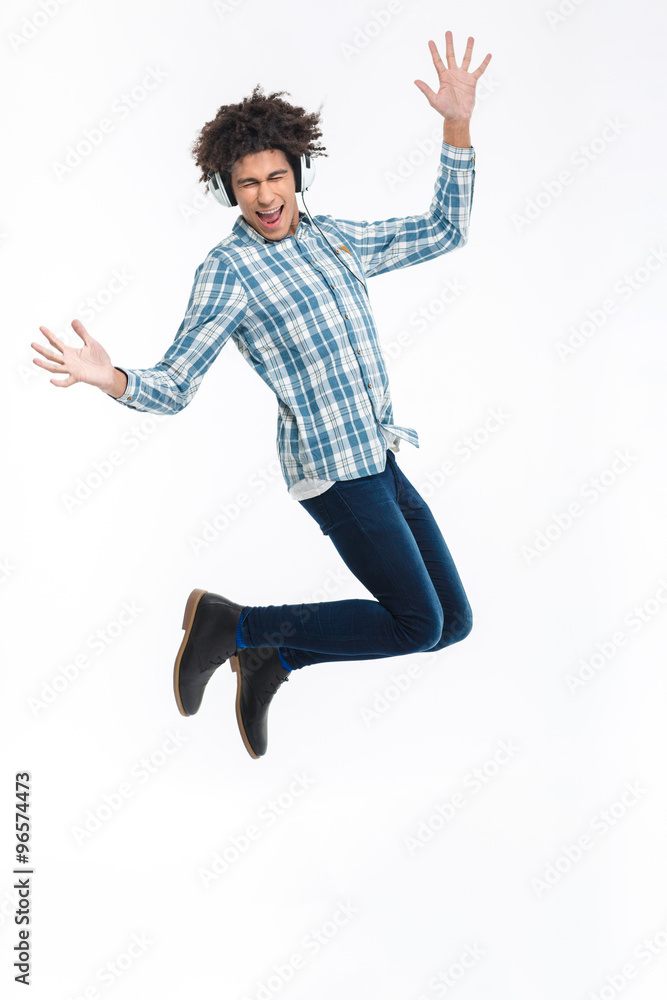 Cheerful afro american man in headphones jumping