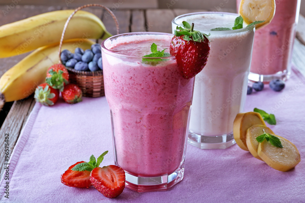 Glasses of fresh cold smoothie with fruit and berries, on the table, close-up Glasses of fresh cold smoothie with fruit and berries, on the table, close-up