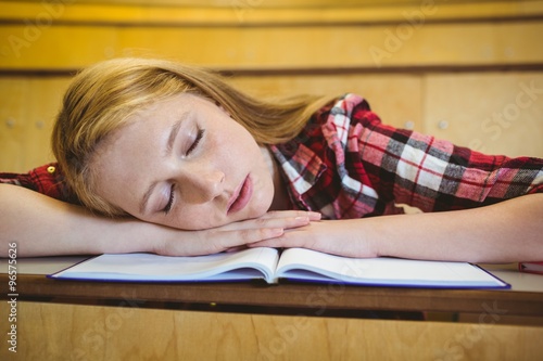 Pretty student sleeping on notebook