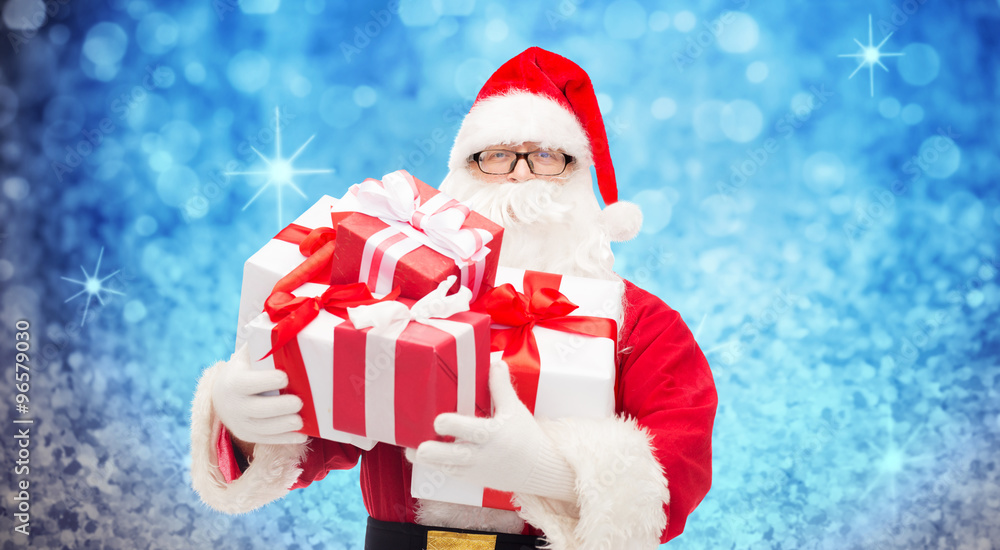 man in costume of santa claus with gift boxes man in costume of santa claus with gift boxes