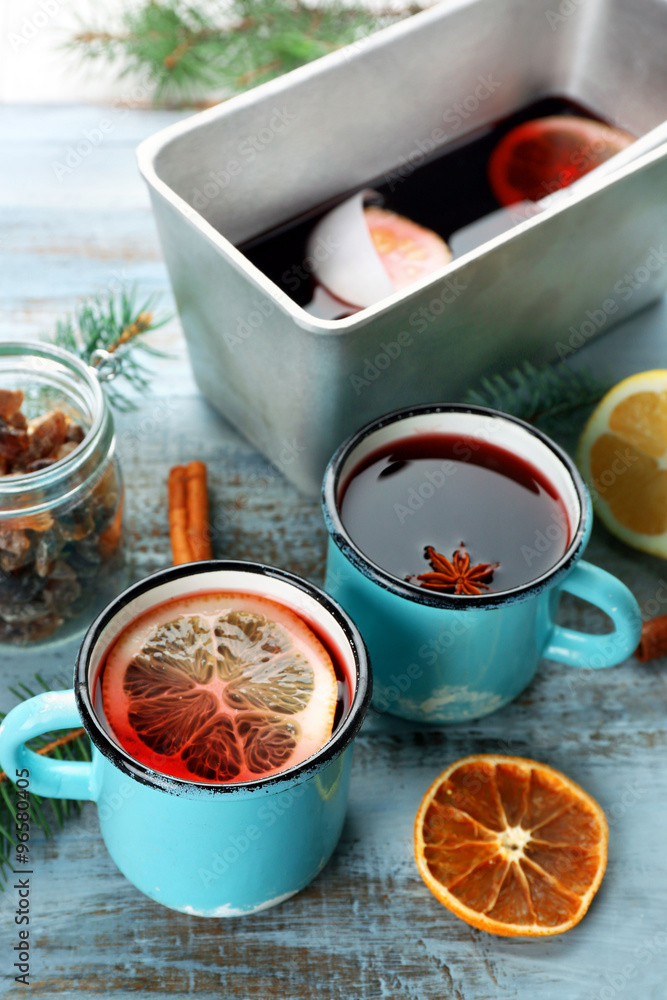 Tasty mulled wine and spices, on blue wooden background, close-up Tasty mulled wine and spices, on blue wooden background, close-up