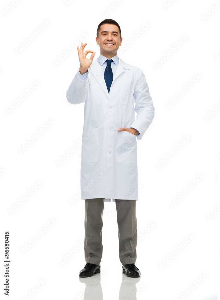 smiling doctor in white coat showing ok hand sign smiling doctor in white coat showing ok hand sign
