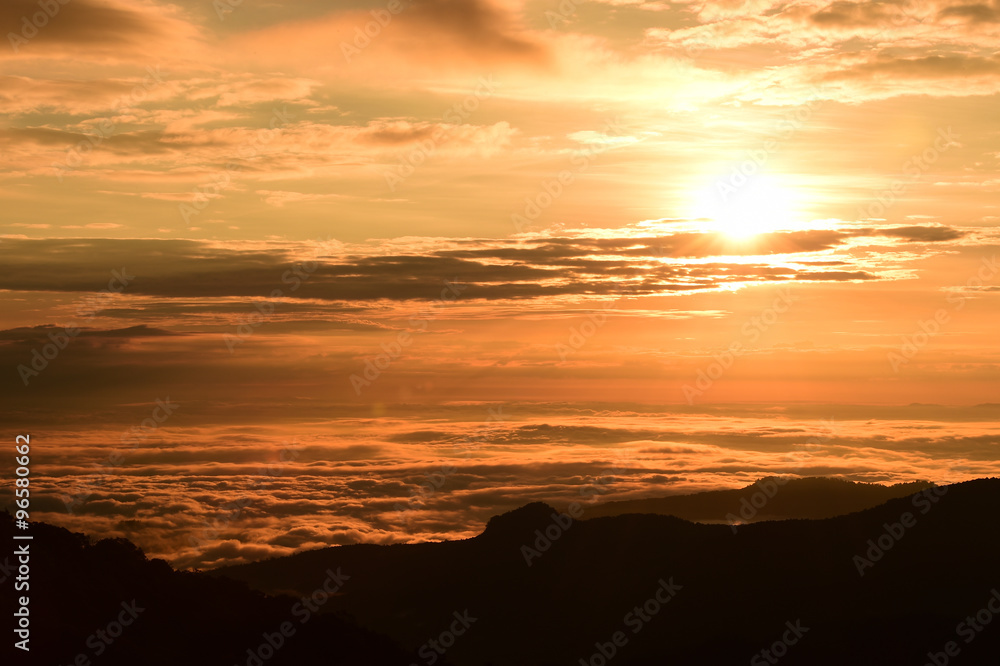 Beautiful sunset at the mountains. Colorful landscape with sun and orange sky