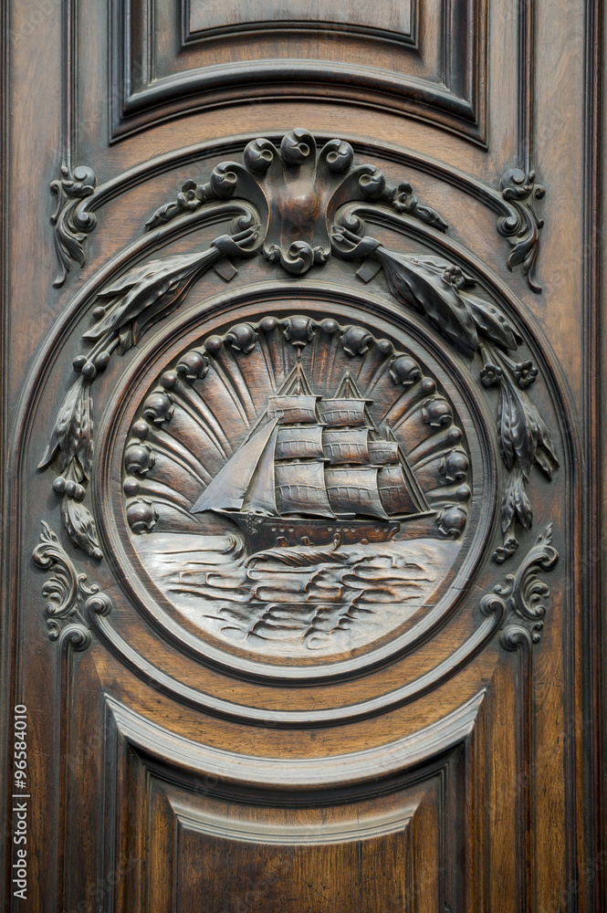 Architectural detail of an old wood door on the exterior of a traditional building in on the historical Avenida Rio Branco in Centro, Rio de Janeiro, Brazil