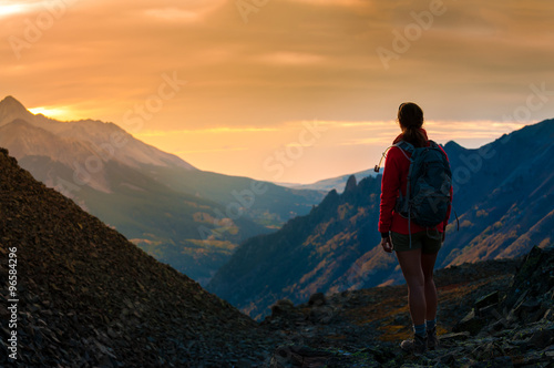 Backpacker Girl Looking at Sunset Colorado Mountains