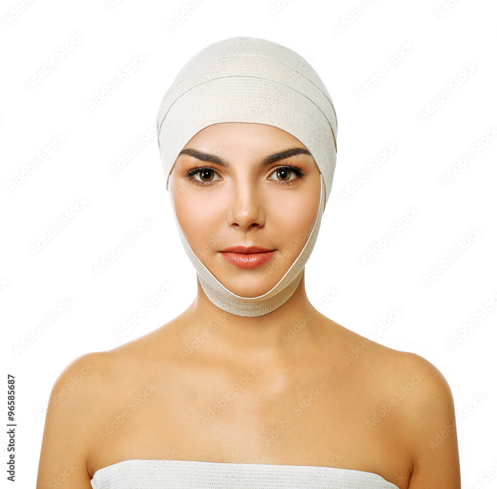 Young beautiful woman with an elastic bandage on her head, isolated on white Young beautiful woman with an elastic bandage on her head, isolated on white