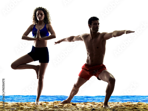 Fototapeta couple on the beach yoga exercices