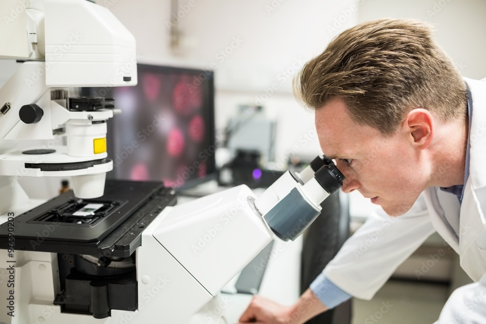 Scientist looking through a microscope Scientist looking through a microscope