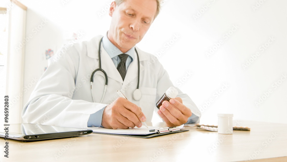 Doctor writing down medical instructions to use. Doctor writing down medical instructions to use.