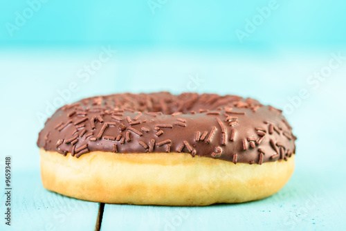 Chocolate Donut With Sparkles On Blue Background