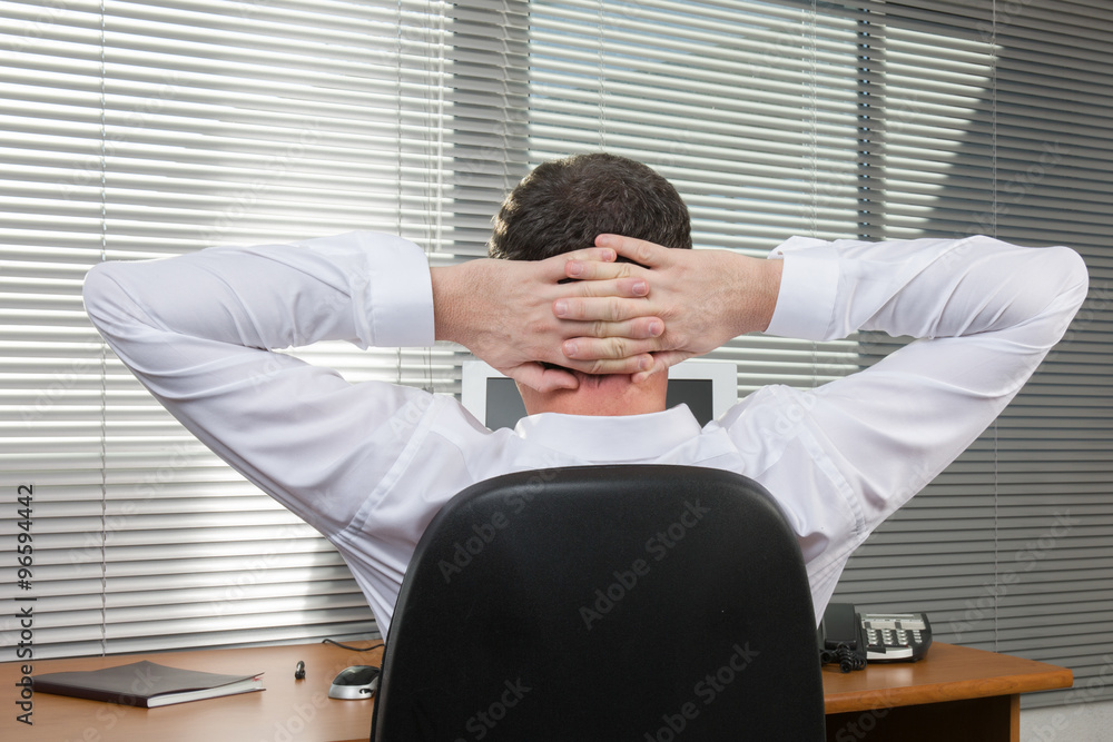 Rear view of the man on the chair relaxing at office Rear view of the man on the chair relaxing at office
