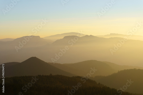 mountain silhouettes at sunset with haze