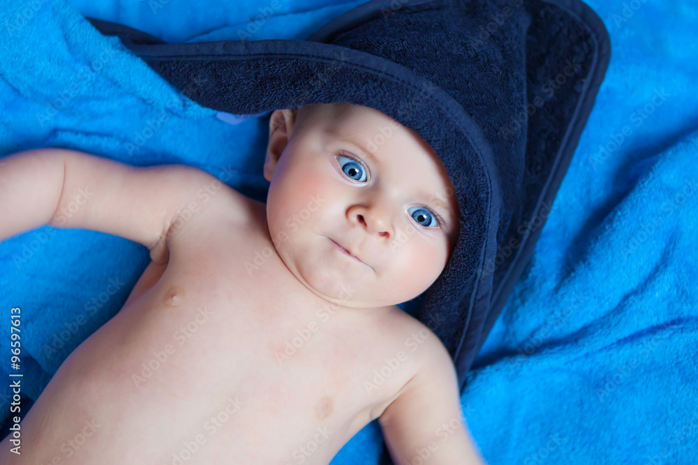 Little kid baby boy against blue bath towel Little kid baby boy against blue bath towel