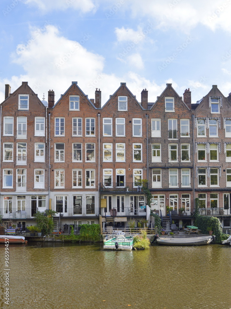 Cute line of houses in Amsterdam on a canal