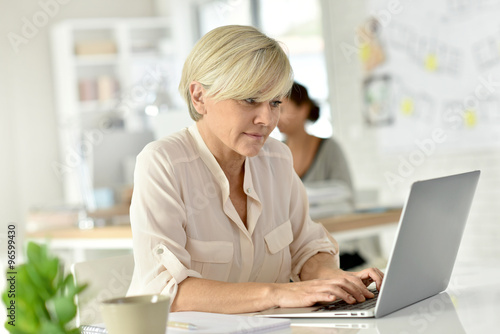 Senior businesswoman in office working on laptop computer