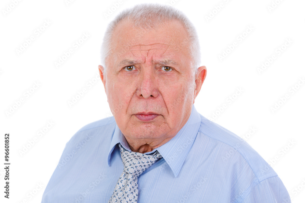 Close-up portrait of serious and strict senior old businessman, dressed in blue shirt and tie, isolated on white background. Human emotions and facial expressions Close-up portrait of serious and strict senior old businessman, dressed in blue shirt and tie, isolated on white background. Human emotions and facial expressions