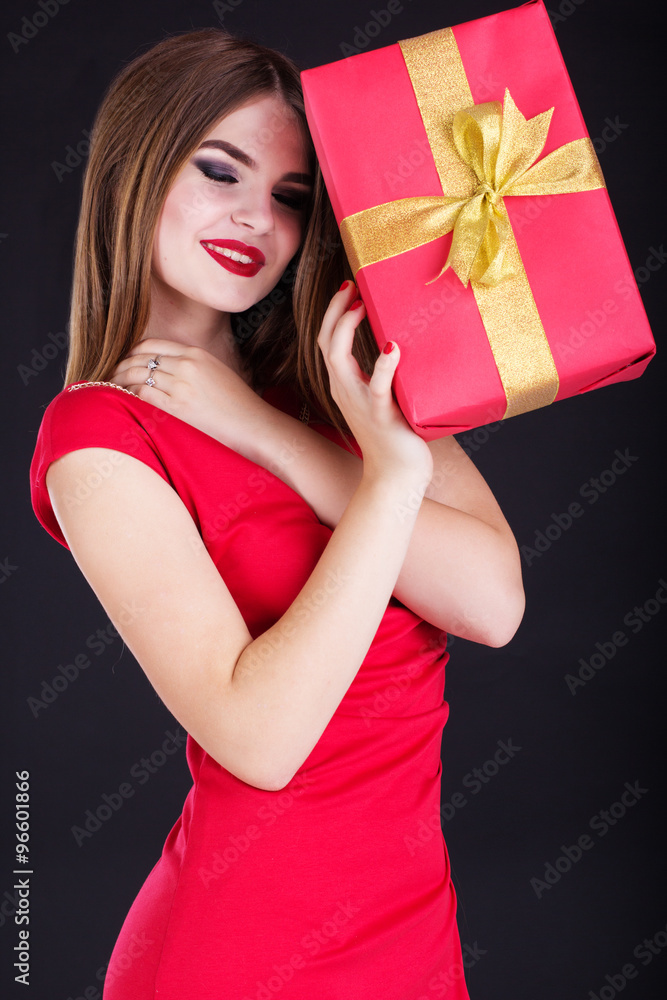 Pretty girl is wearing red dress with gift box Pretty girl is wearing red dress with gift box