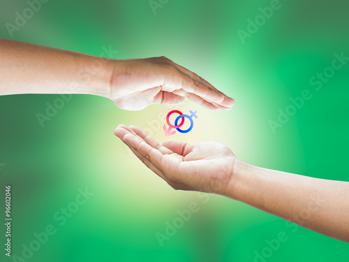 Wallpaper Mural Human hand holding Mars Venus or Male Female symbol. Safe Sex co Torontodigital.ca