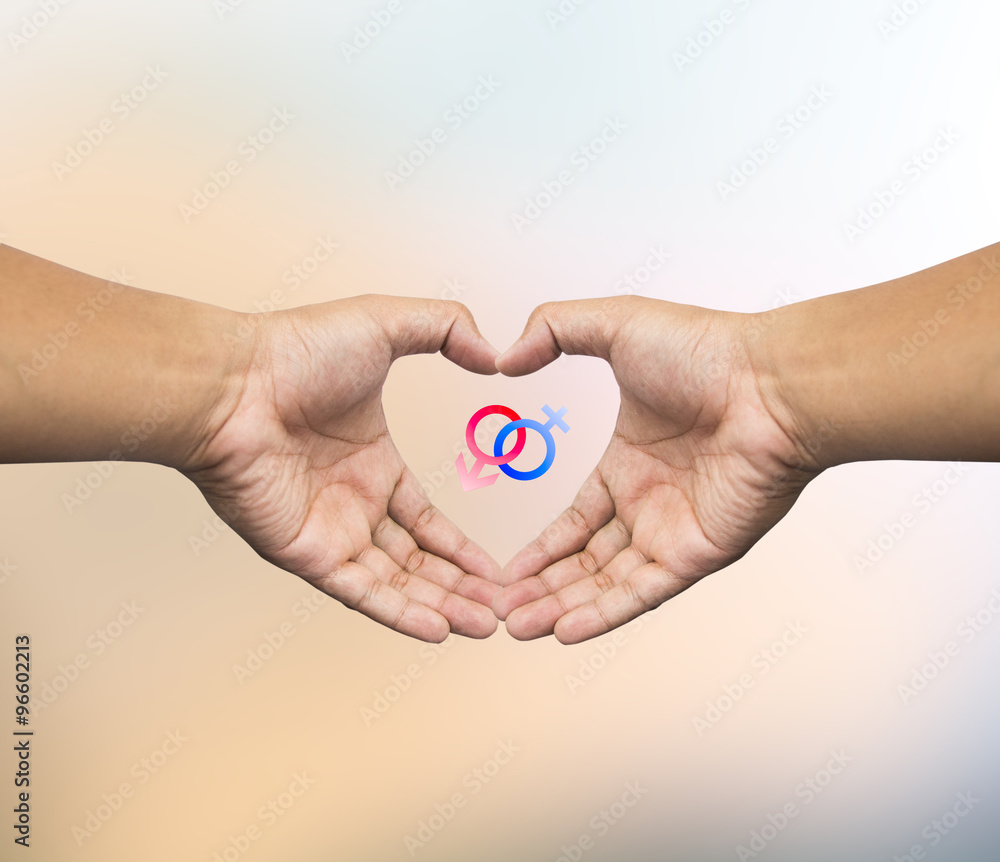 Human hand holding Mars Venus or Male Female symbol. Safe Sex co Human hand holding Mars Venus or Male Female symbol. Safe Sex co